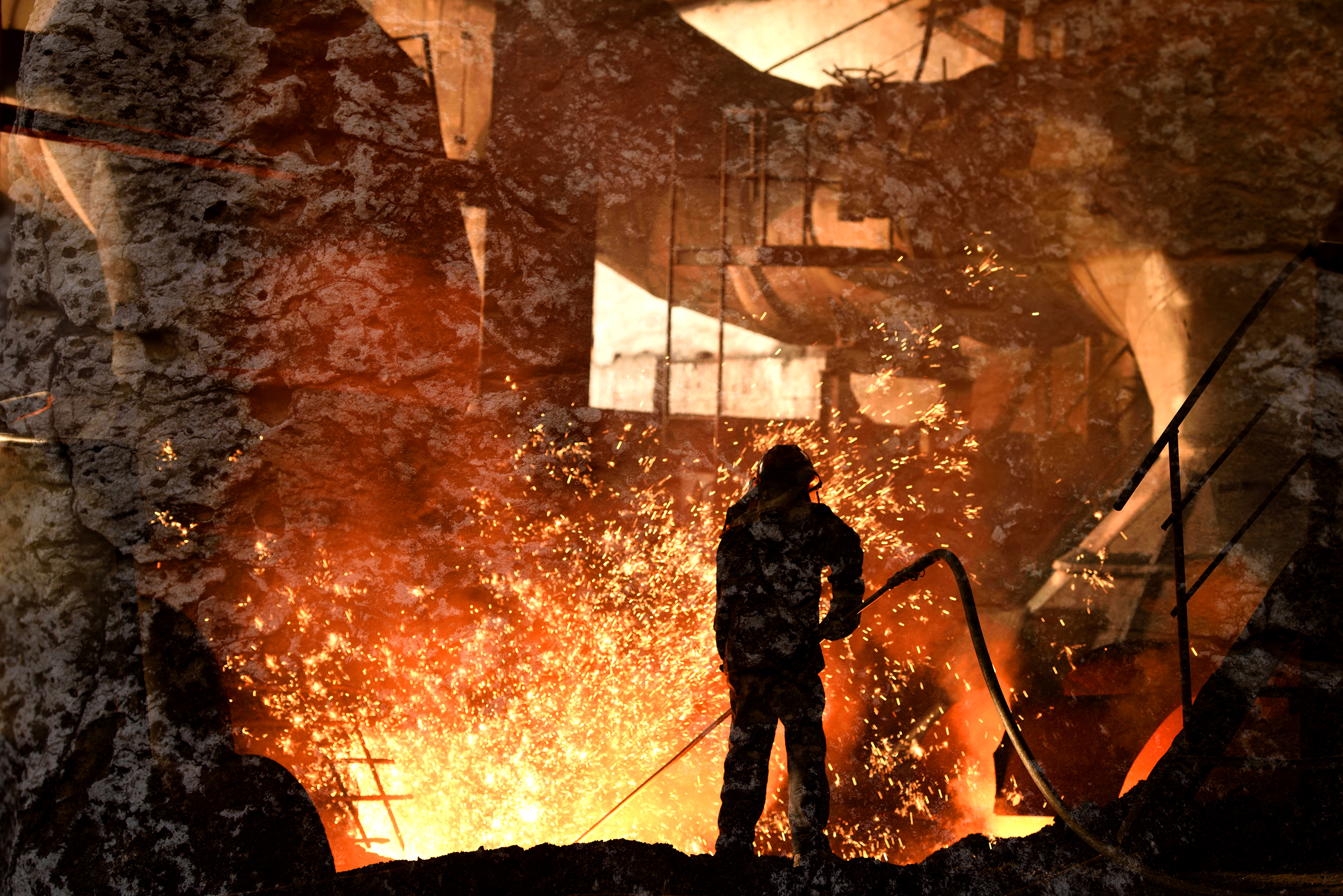 Steelworker working with very hot materials, amidst sparks.