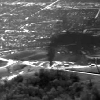 A dark plume drifts into the sky. In 2015, EDF flew over the Aliso Canyon gas leak with an infrared camera to document the pollution.
