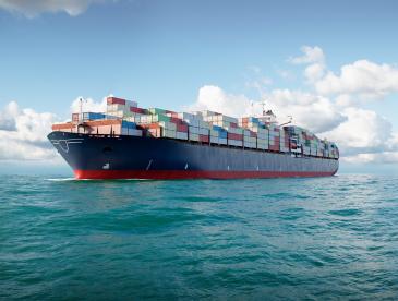 A large ship with shipping containers on it at sea.